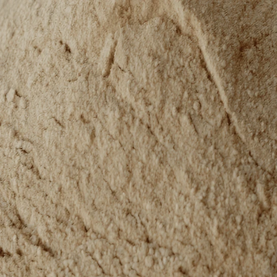 Beige rock phosphate powder with a cracked surface